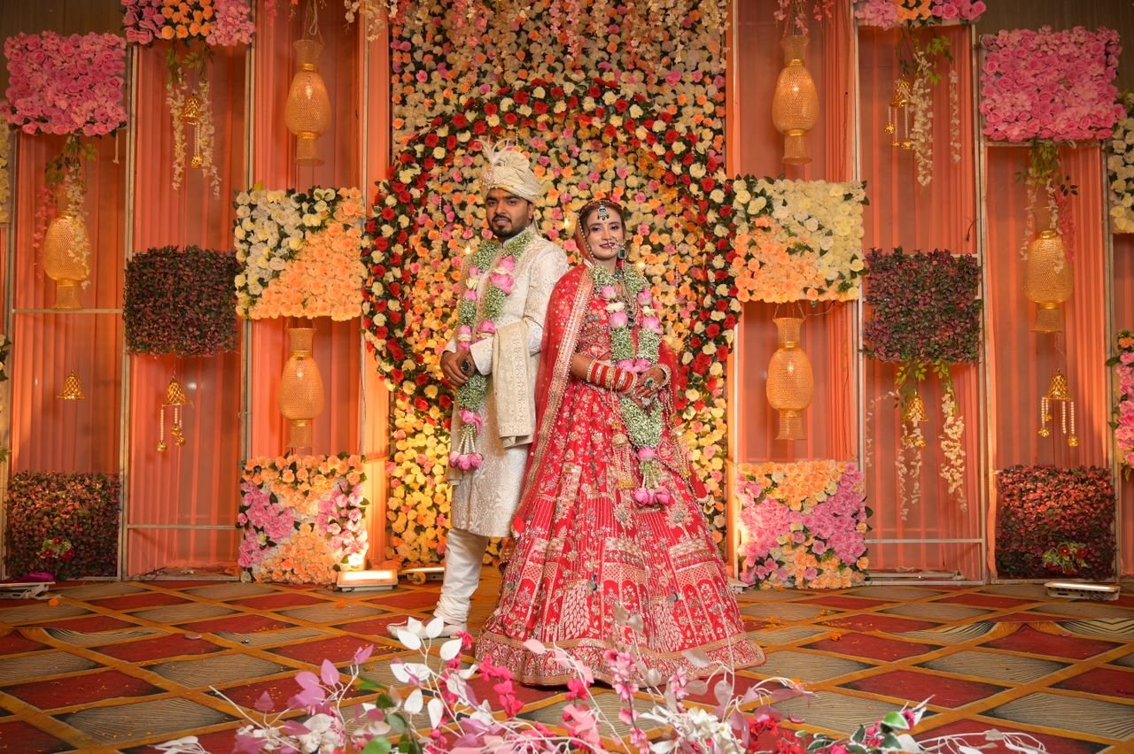 Mastering the First Impression: Your intriguing post title goes here Elegant Indian couple posing at their wedding ceremony with floral decor background.