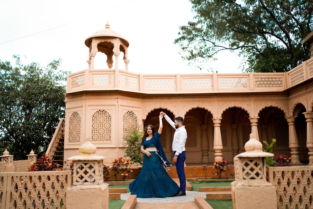 Crafting Captivating Headlines: Your awesome post title goes here Couple enjoys a romantic dance at a heritage site in Gurugram, India, showcasing timeless love.