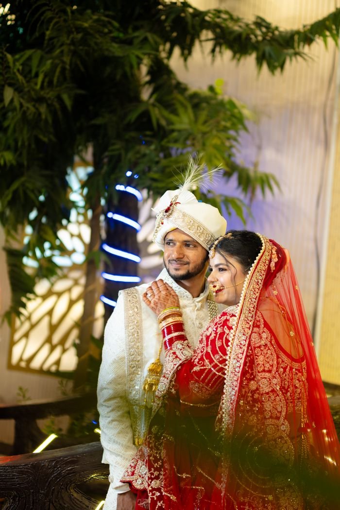 our-story-02 Beautiful Indian bride and groom in traditional wedding attire, captured at a vibrant ceremony.